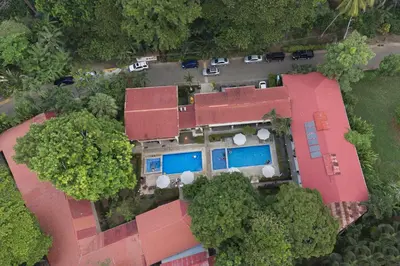 an aerial view of a house with a swimming pool at Hotel Mar de Luz in Jacó