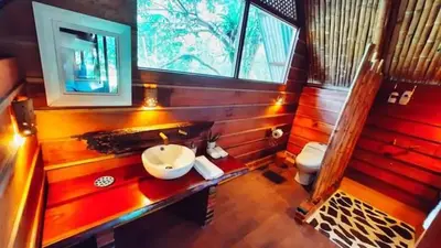 a bathroom with a sink and a toilet at Poponé Farm & Lodge in Guápiles