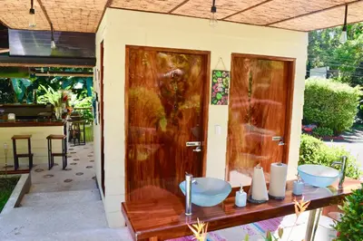 a bathroom with two sinks on a house at Hotel Playa Espadilla & Gardens in Manuel Antonio