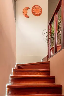 a set of stairs with a clock on the wall at Delcafetalcr in San José