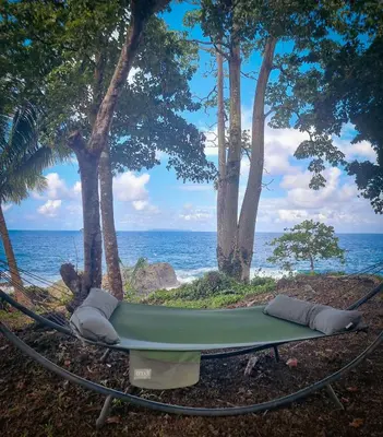a hammock with a view of the ocean at The Jaguars Jungle Rainforest Lodge - All meals included in San Pedrillo