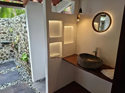 a bathroom with a sink and a mirror at The Jaguars Jungle Rainforest Lodge - All meals included in San Pedrillo