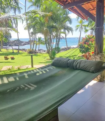a green hammock with the ocean in the background at The Jaguars Jungle Rainforest Lodge - All meals included in San Pedrillo