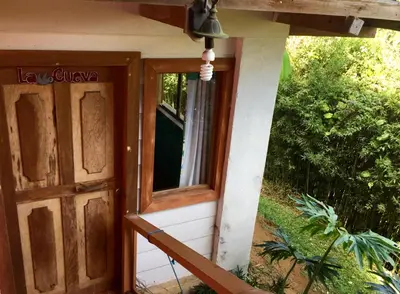 an open door of a house with a window at Spanish by the River - Turrialba in Turrialba