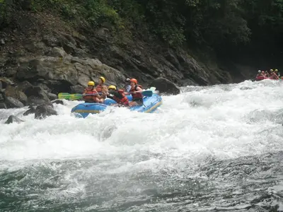 a group of people in a raft in a river at Spanish by the River - Turrialba in Turrialba