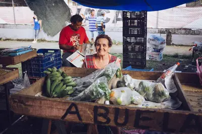 a woman sitting in a box of fruit and vegetables at Spanish by the River - Turrialba in Turrialba