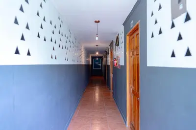 a hallway with blue and white walls and a tile floor at Point Break Santa Teresa in Santa Teresa Beach
