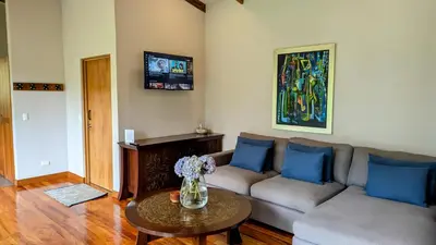 a living room with a couch and a table at Olingo Monteverde - Stunning Home Near Adventure Parks in Monteverde Costa Rica
