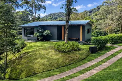 a house in the middle of a yard at Olingo Monteverde - Stunning Home Near Adventure Parks in Monteverde Costa Rica