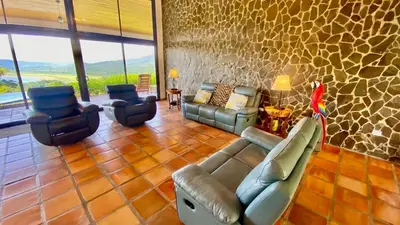 a living room with a couch and two chairs at Serenity House Panoramic Views And Swimming Pool, in El Castillo de la Fortuna