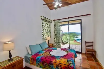 a bedroom with a bed with a table on it at Serenity House Panoramic Views And Swimming Pool, in El Castillo de la Fortuna