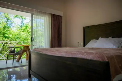 a bedroom with a bed and a sliding glass door at Casa Coco de Mer 1 in Tamarindo