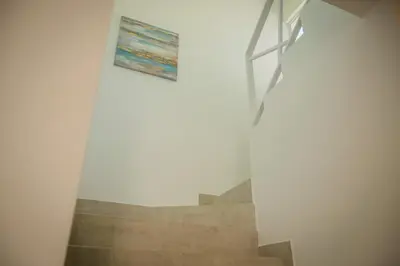 a painting on a wall next to a staircase at Casa Coco de Mer 1 in Tamarindo