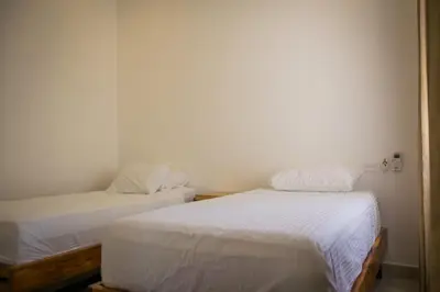 two beds in a room with white sheets at Casa Coco de Mer 1 in Tamarindo