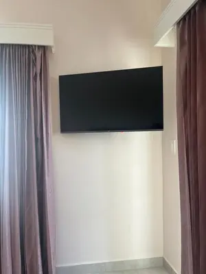a flat screen tv on a wall in a room at Casa Coco de Mer 1 in Tamarindo