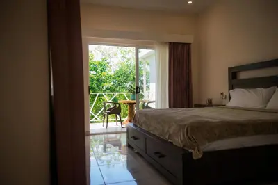 a bedroom with a bed and a sliding glass door at Casa Coco de Mer 2 in Tamarindo