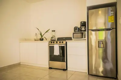 a kitchen with a stainless steel refrigerator at Casa Coco de Mer 2 in Tamarindo