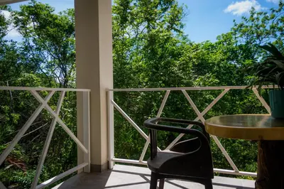 a balcony with a table and chairs and trees at Casa Coco de Mer 2 in Tamarindo
