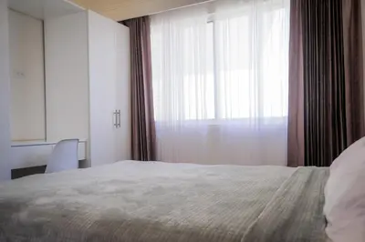 a bedroom with a bed and a large window at Casa Coco de Mer 2 in Tamarindo