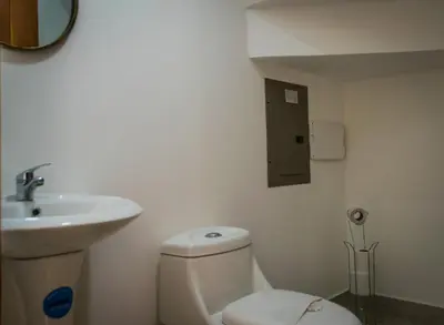 a bathroom with a white toilet and a sink at Casa Coco de Mer 2 in Tamarindo