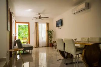 a living room with a dining room table and chairs at Casa Coco de Mer 2 in Tamarindo