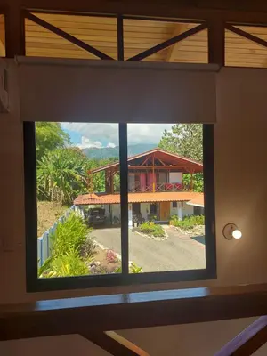 a view of a house through a window at Ibiza Tropical Beach Villas in Uvita