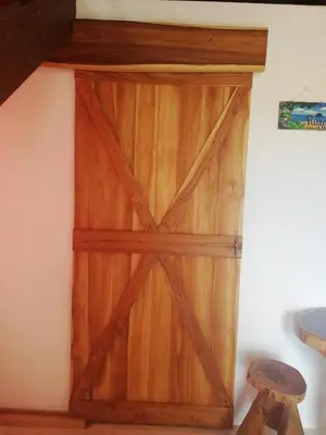 a wooden door in the corner of a room at Ibiza Tropical Beach Villas in Uvita