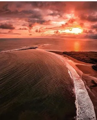 an aerial view of a beach at sunset at Ibiza Tropical Beach Villas in Uvita