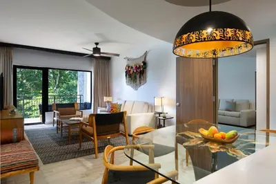 a living room with a table and a dining room at Marriott Vacation Club at Los Sueños in Jacó