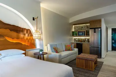a hotel room with a bed and a couch at Marriott Vacation Club at Los Sueños in Jacó