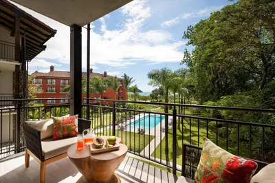 a balcony with a view of a pool at Marriott Vacation Club at Los Sueños in Jacó