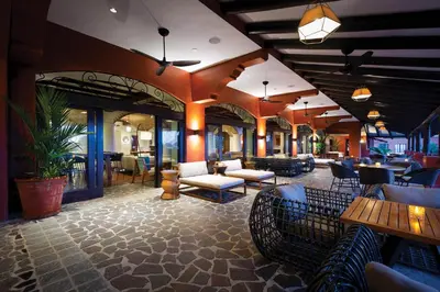a restaurant with couches and tables and chairs at Marriott Vacation Club at Los Sueños in Jacó