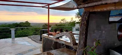 a patio with a hammock on top of a building at El Castillo Monte Campana in Puntarenas