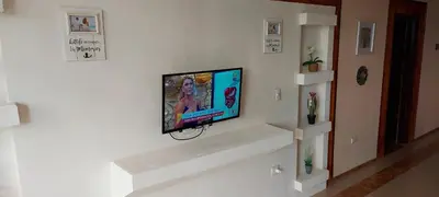 a flat screen tv hanging on a wall at El Castillo Monte Campana in Puntarenas