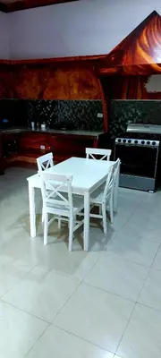 a white table and two white chairs in a kitchen at El Castillo Monte Campana in Puntarenas