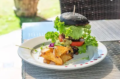 a sandwich on a white plate on a table at Sunset del Mar Beach Resort in Esterillos Este