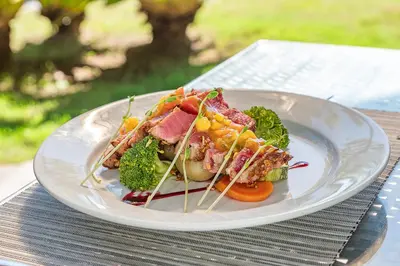 a white plate of food on a table at Sunset del Mar Beach Resort in Esterillos Este