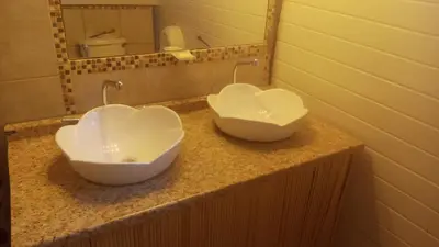 two bowls in the shape of hearts sit on a bathroom counter at CHEZ NOUS in Carrillo