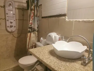 a bathroom with a sink and a toilet at CHEZ NOUS in Carrillo