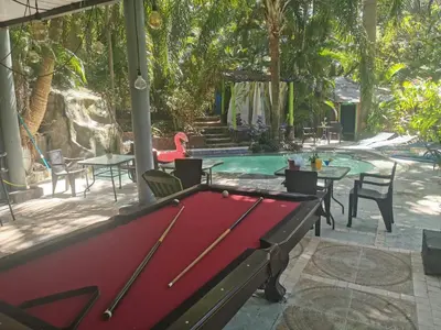 a pool table in front of a swimming pool at CHEZ NOUS in Carrillo