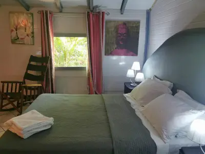 a bedroom with a bed with two towels on it at CHEZ NOUS in Carrillo