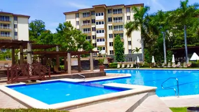 a large swimming pool in front of a building at Casa apartamento Costa Linda jaco in Jacó
