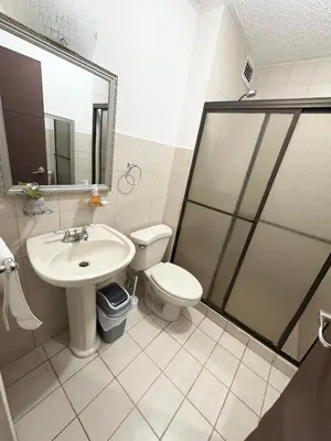 a bathroom with a toilet and a sink and a shower at Casa apartamento Costa Linda jaco in Jacó