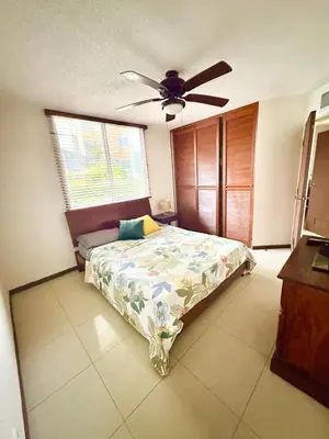 a bedroom with a bed and a ceiling fan at Casa apartamento Costa Linda jaco in Jacó
