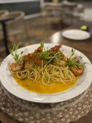 a plate of food with shrimp and spaghetti on a table at Layan Hotel & Spa in Manuel Antonio