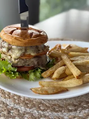 a sandwich and french fries on a white plate at Layan Hotel & Spa in Manuel Antonio