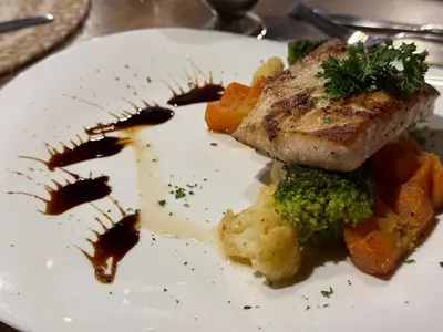 a plate of food with meat and broccoli on it at Layan Hotel & Spa in Manuel Antonio