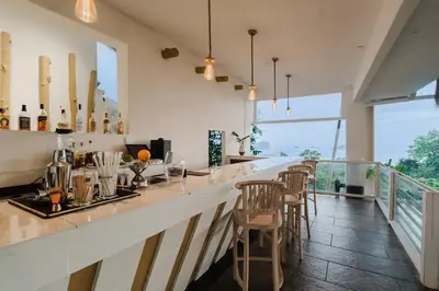 a bar with chairs and a counter with a view at Layan Hotel & Spa in Manuel Antonio