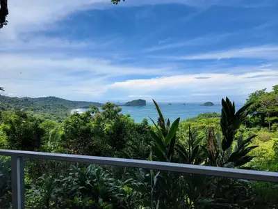 a view of the ocean from the balcony of a house at Layan Hotel & Spa in Manuel Antonio