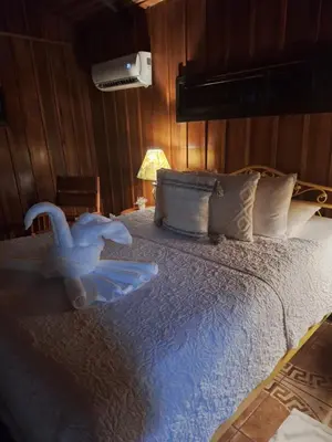 a bedroom with a bed with a bird on it at Casona Rústica & Bungalow in Fortuna